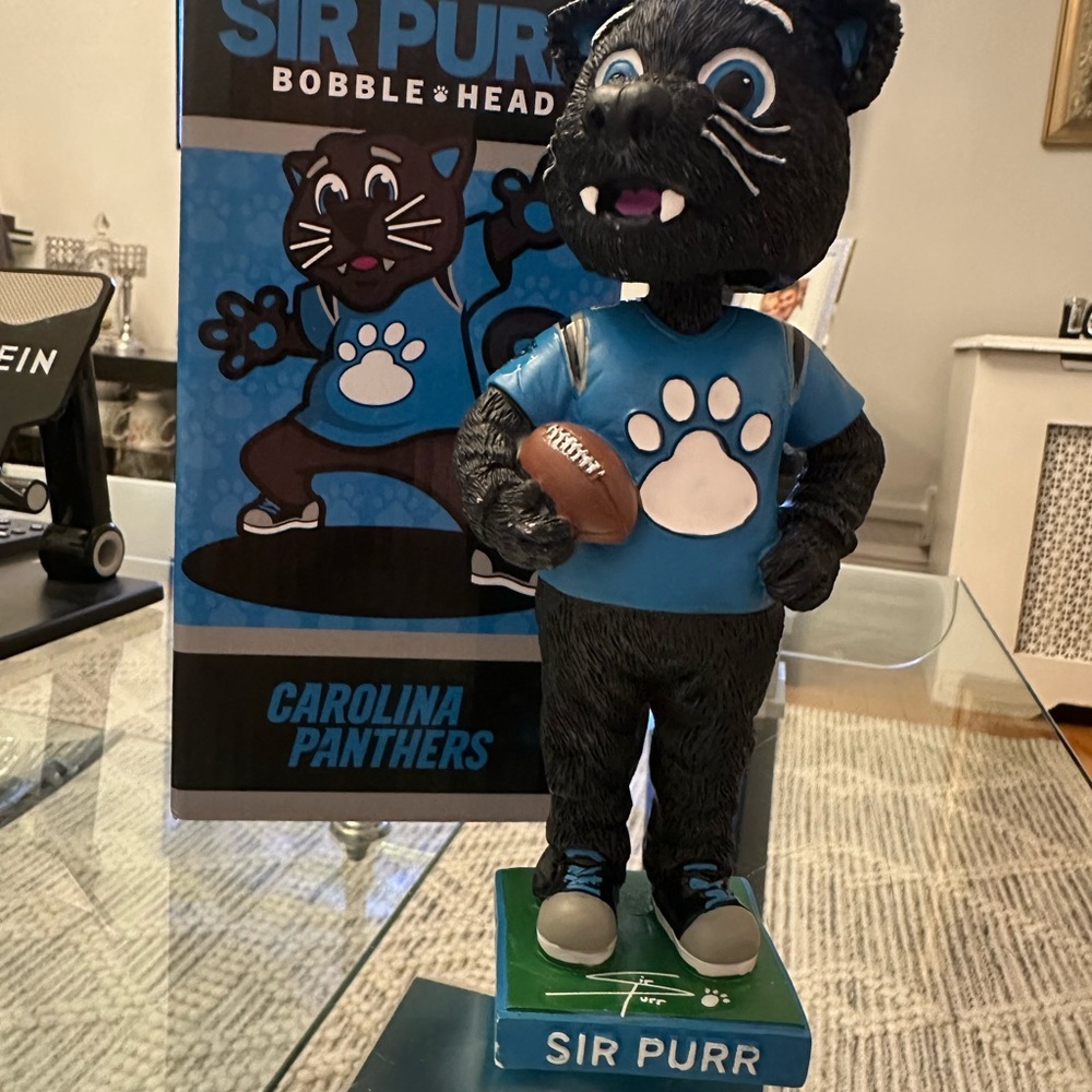 The item in the image is a Sir Purr Carolina Panthers mascot figurine/statue.